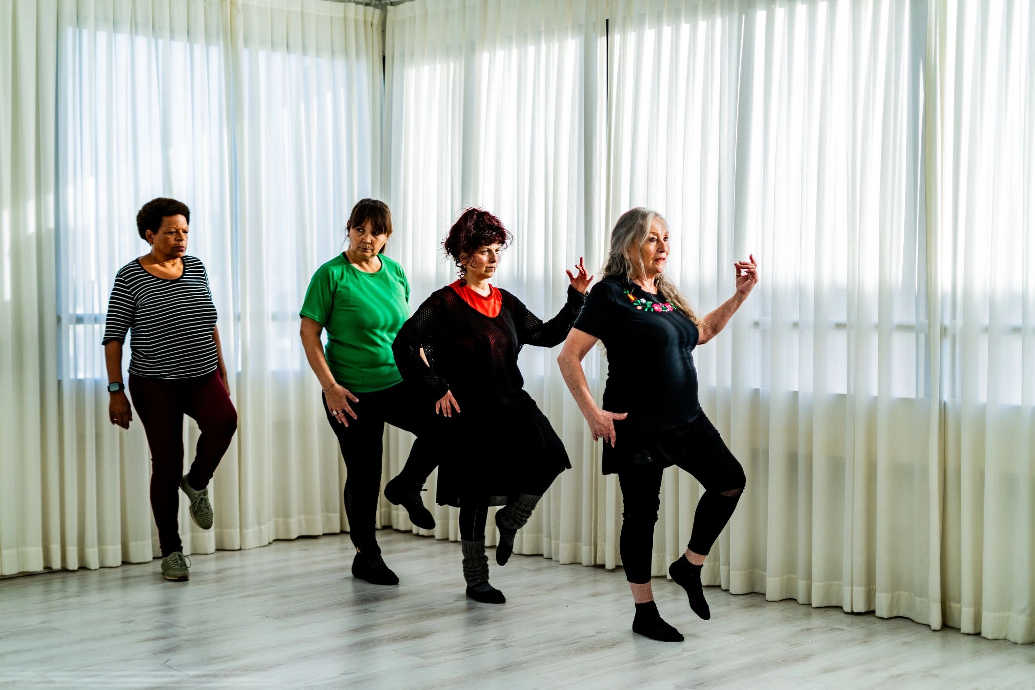 Women practicing dance together in a studio